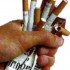 hand crushing pack of cigarettes
